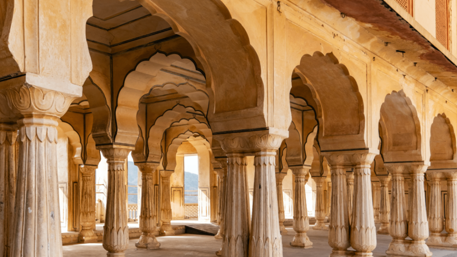 A sunlit colonnade of scalloped arches