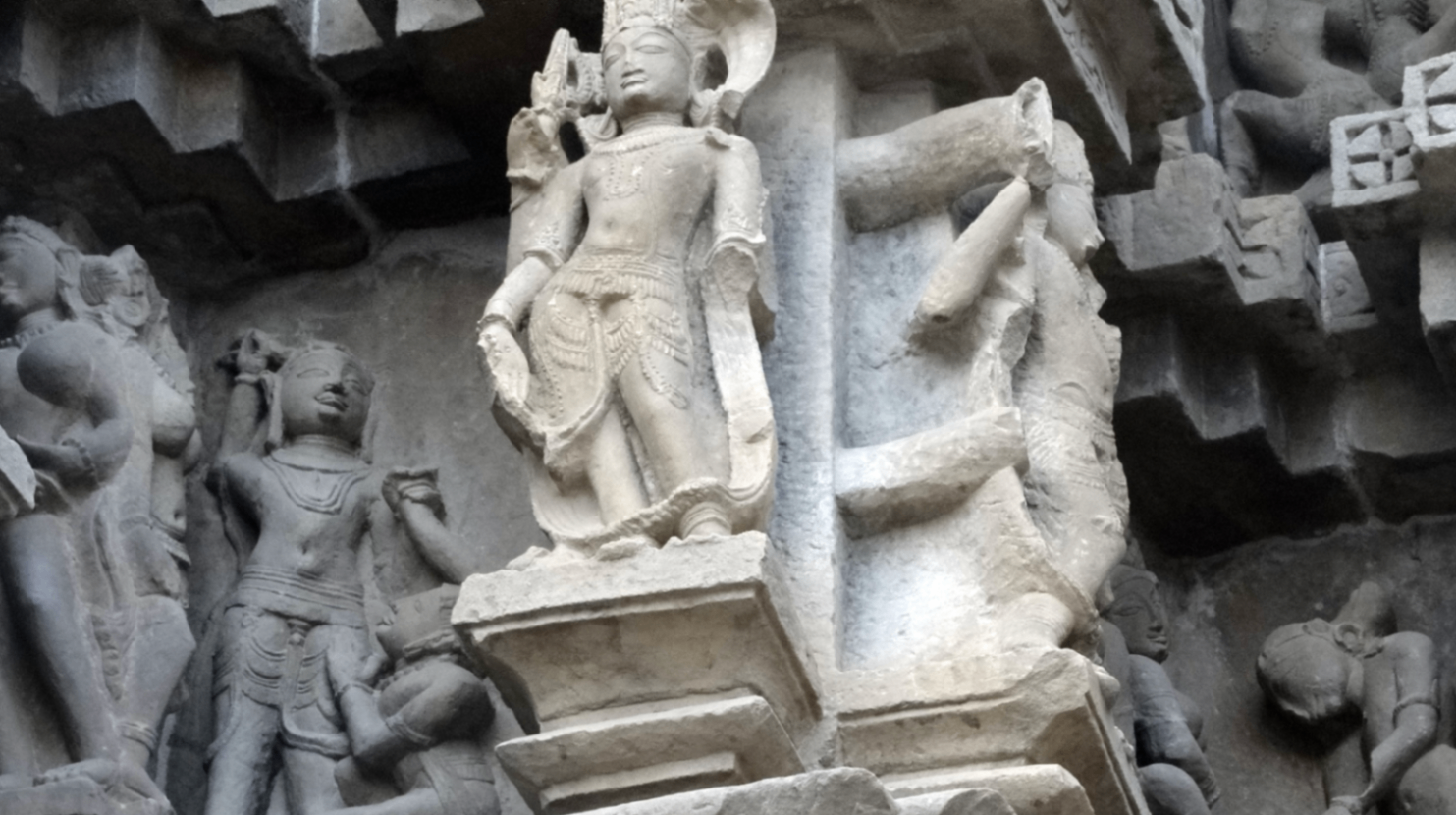 Weathered stone sculptures on a temple facade